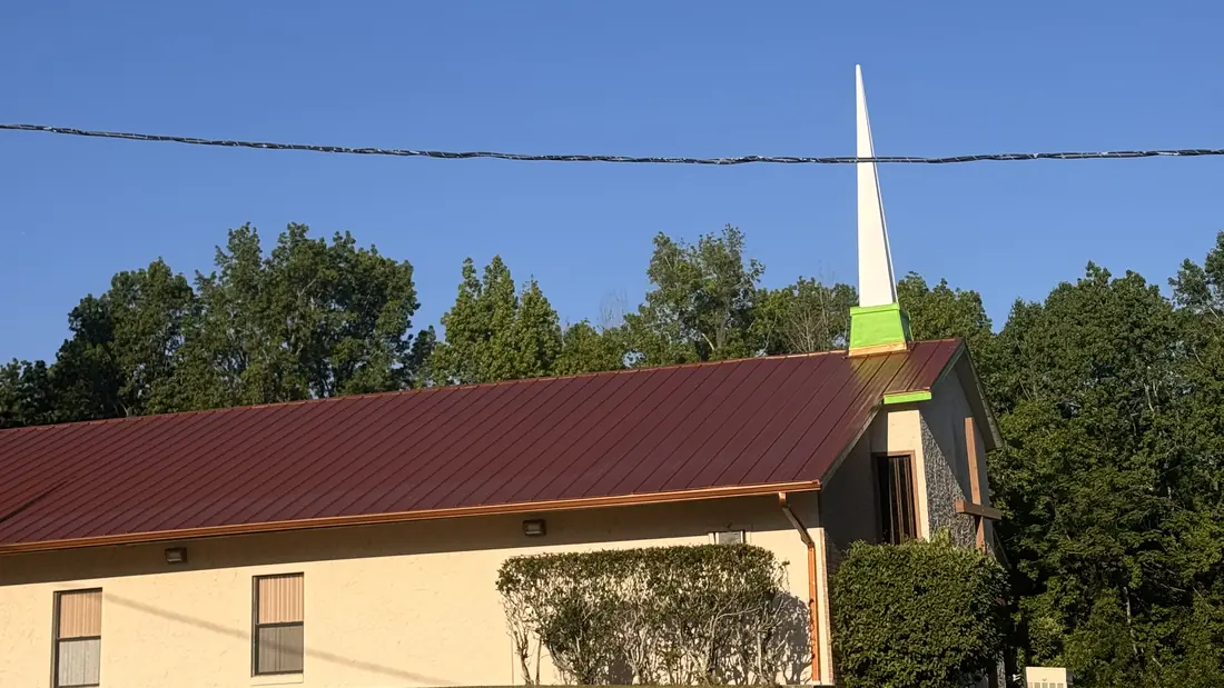 Red standing-seam metal roof installed by State Certified Roofing in Central Florida